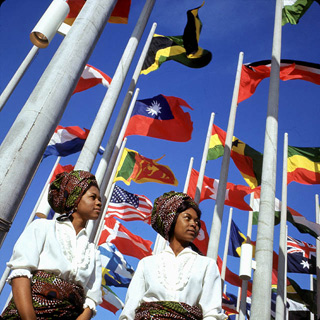 Two young women in front of flags at Place des Nations, Expo 67, on opening day.