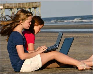 Two girls working on the beach.