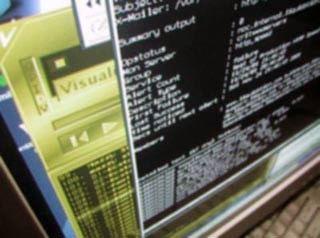 A photo of a computer screen with several overlapping application windows open, each displaying text.